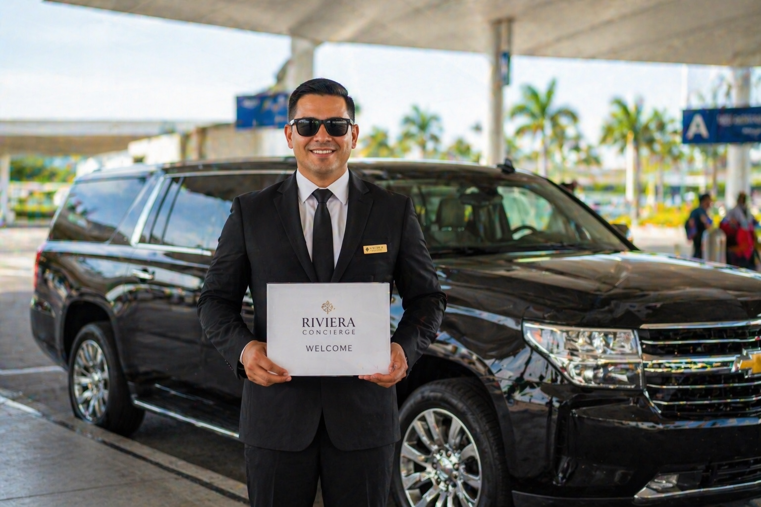 Professional driver for private Cancun airport transfer to Tulum holding welcome sign